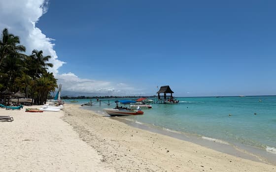 The quiet beach and pier at Trou aux Biches